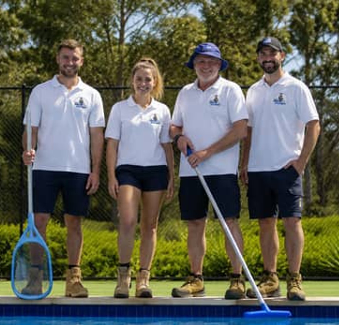 Pool cleaning team servicing a residential pool